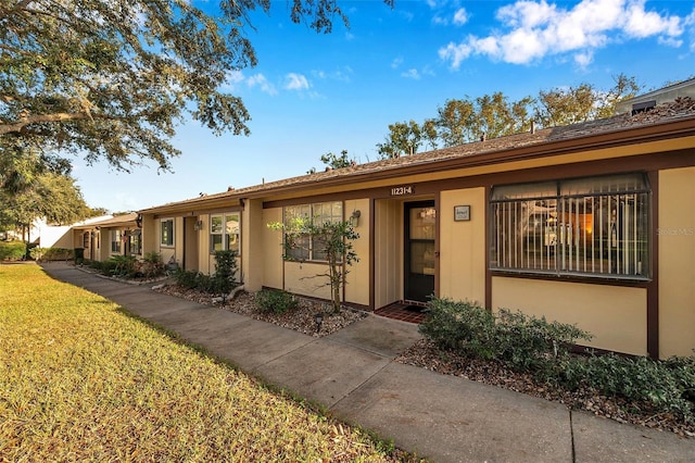 ranch-style home with a front lawn