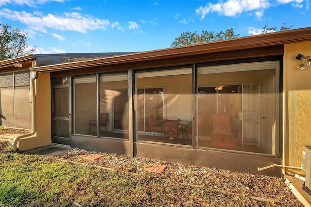 back of house featuring a sunroom