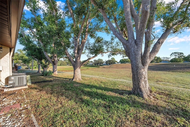 view of yard featuring central AC and a rural view