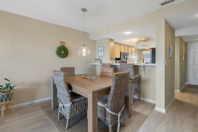 8141 Aquila St Unit 347, Port Richey, FL 34668 - dining room featuring light wood finished floors, baseboards, and ceiling fan