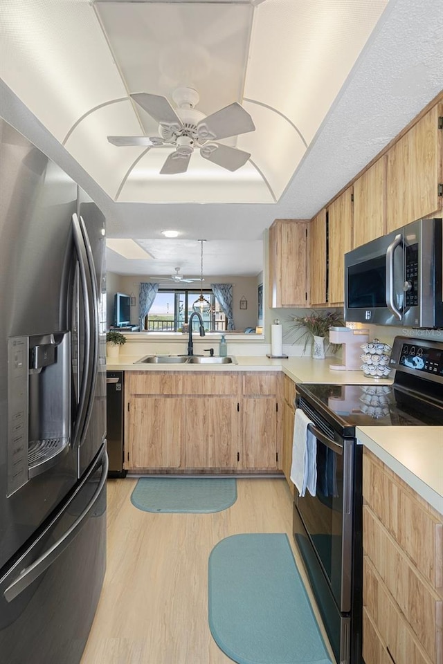 8141 Aquila St Unit 347, Port Richey, FL 34668 - kitchen featuring stainless steel appliances, a sink, light countertops, light wood finished floors, and ceiling fan