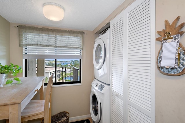 8141 Aquila St Unit 347, Port Richey, FL 34668 - laundry room with stacked washing machine and dryer, baseboards, and a textured ceiling