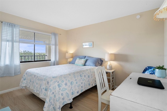 8141 Aquila St Unit 347, Port Richey, FL 34668 - bedroom with wood finished floors, baseboards, and multiple windows