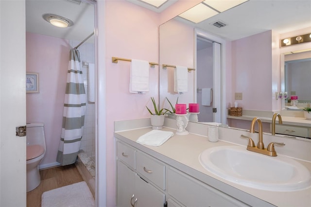 8141 Aquila St Unit 347, Port Richey, FL 34668 - bathroom featuring toilet, vanity, wood finished floors, and a shower with shower curtain