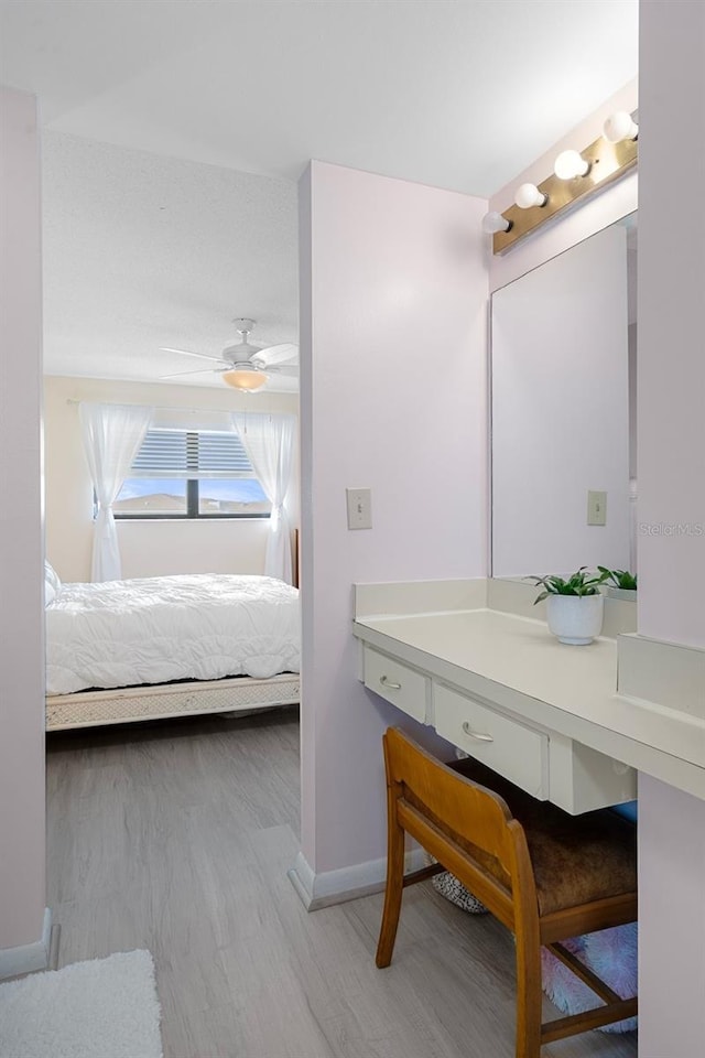 8141 Aquila St Unit 347, Port Richey, FL 34668 - ensuite bathroom with wood finished floors, vanity, baseboards, and a ceiling fan