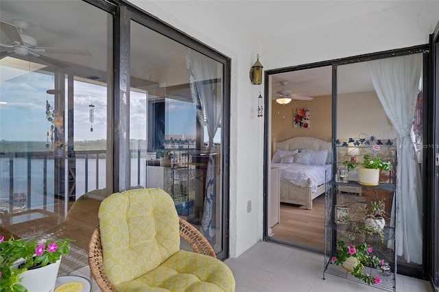 8141 Aquila St Unit 347, Port Richey, FL 34668 - sunroom featuring ceiling fan, a water view, and tile patterned floors