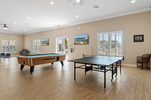 rec room featuring a wealth of natural light, ceiling fan, and light wood-type flooring