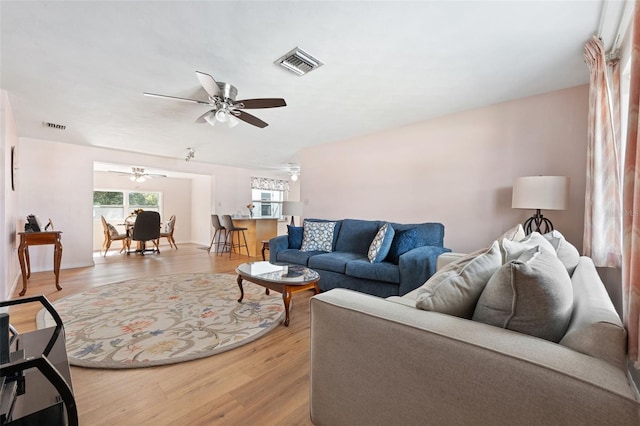 living room featuring light hardwood / wood-style flooring and ceiling fan