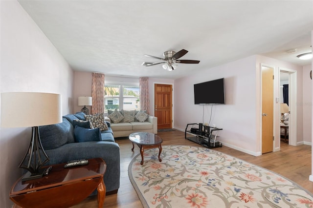 living room featuring light wood-type flooring and ceiling fan