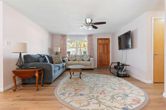 living room with ceiling fan and light hardwood / wood-style flooring