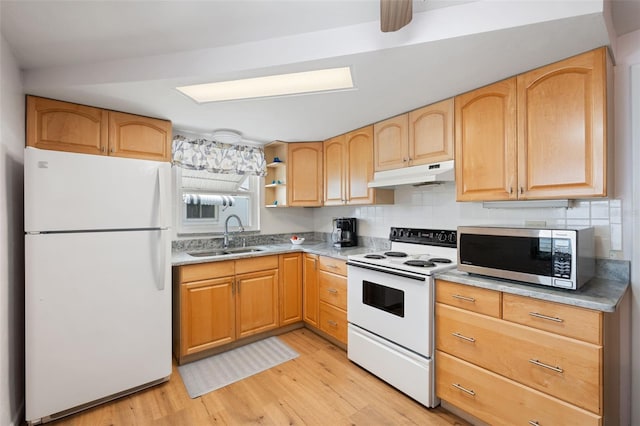 kitchen featuring light wood-type flooring, backsplash, white appliances, sink, and light brown cabinets