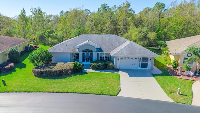 view of front of property featuring a garage and a front lawn