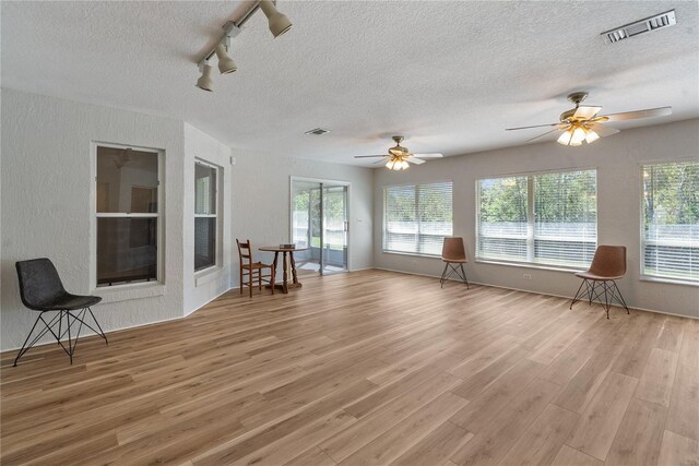 interior space featuring track lighting and ceiling fan