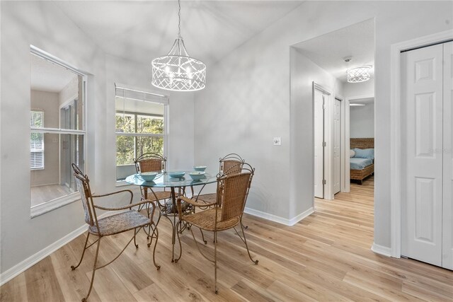 dining room featuring an inviting chandelier and light hardwood / wood-style floors