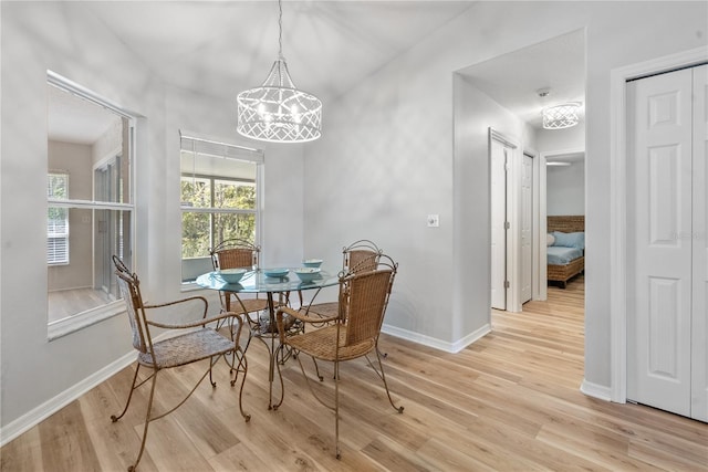 dining space featuring a chandelier and light hardwood / wood-style floors