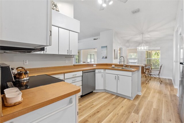 kitchen with pendant lighting, white cabinetry, dishwasher, and sink