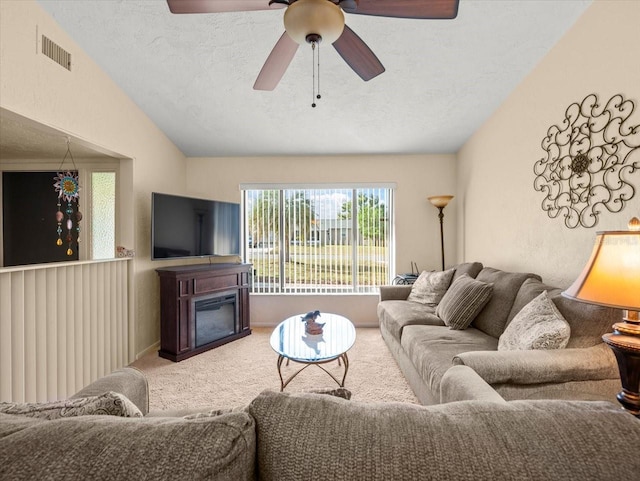 carpeted living room with a textured ceiling, ceiling fan, and lofted ceiling