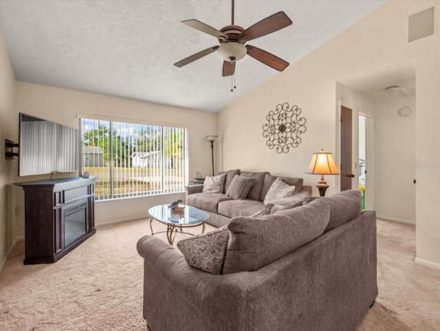 carpeted living room with a textured ceiling, ceiling fan, and vaulted ceiling