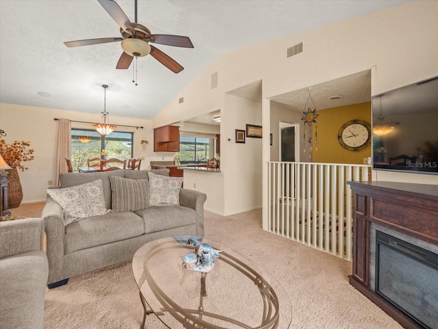 living room with light carpet, ceiling fan, and vaulted ceiling