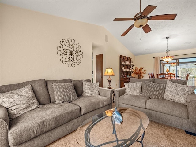 carpeted living room featuring ceiling fan and vaulted ceiling