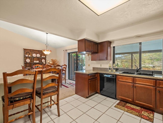 kitchen featuring dishwasher, light tile patterned floors, a textured ceiling, and a healthy amount of sunlight