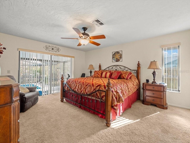 carpeted bedroom featuring a textured ceiling, access to outside, and ceiling fan