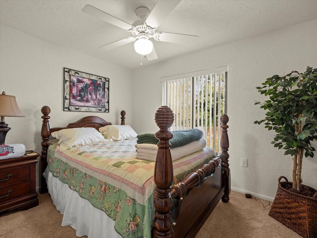 bedroom featuring ceiling fan, light colored carpet, and a textured ceiling