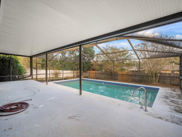 view of pool with a patio and glass enclosure