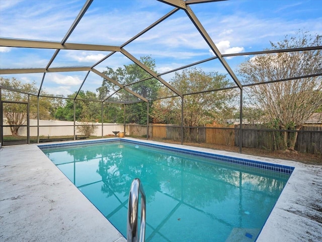 view of pool with glass enclosure