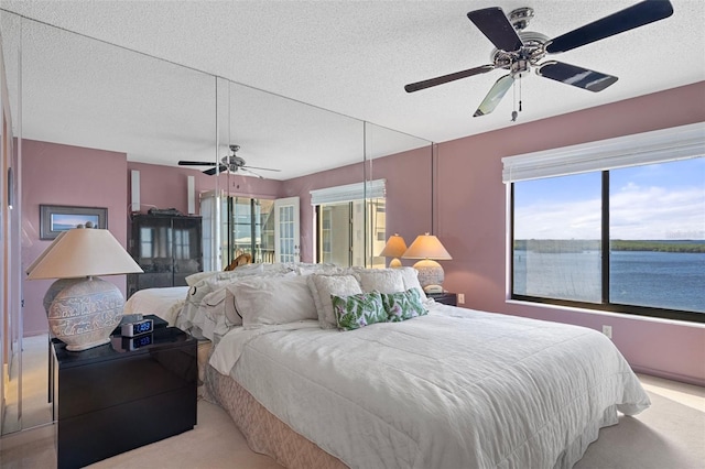 4620 Bay Blvd Unit 1148, Port Richey, FL 34668 - carpeted bedroom with multiple windows, a textured ceiling, and ceiling fan