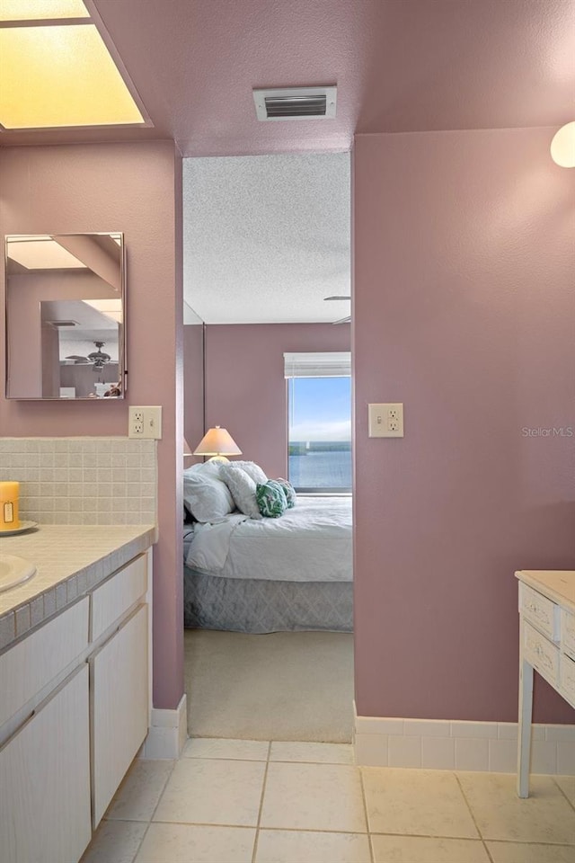 4620 Bay Blvd Unit 1148, Port Richey, FL 34668 - bathroom with ensuite bathroom, vanity, a textured ceiling, and tile patterned floors