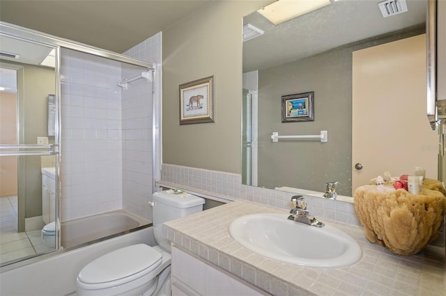4620 Bay Blvd Unit 1148, Port Richey, FL 34668 - bathroom with toilet, vanity, and shower / bath combination with glass door