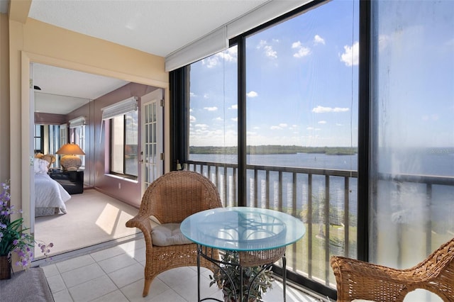 4620 Bay Blvd Unit 1148, Port Richey, FL 34668 - sunroom / solarium with a water view, tile patterned floors, and carpet flooring