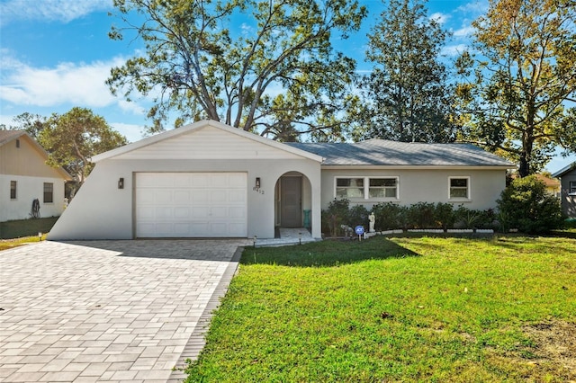 ranch-style house featuring a garage and a front yard