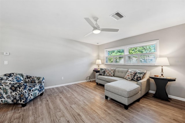 living room with light wood-type flooring and ceiling fan