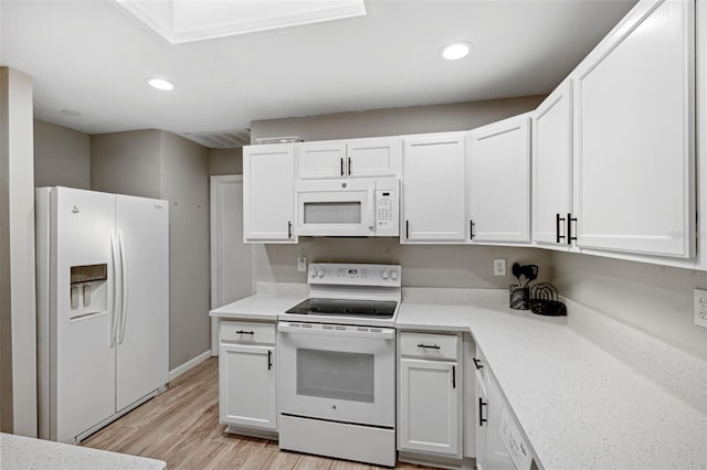 kitchen featuring light wood-type flooring, white appliances, and white cabinets