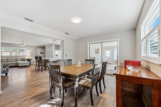 dining area featuring ceiling fan and wood-type flooring