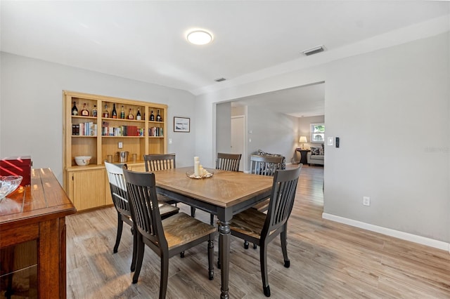 dining space with light hardwood / wood-style floors