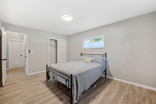 bedroom with a closet and light hardwood / wood-style flooring