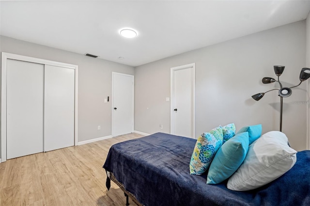 bedroom featuring hardwood / wood-style flooring and a closet