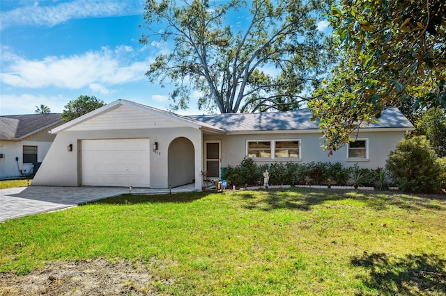 ranch-style house featuring a front lawn and a garage