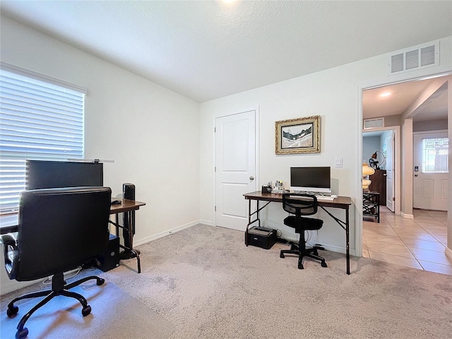 office featuring light carpet and a textured ceiling