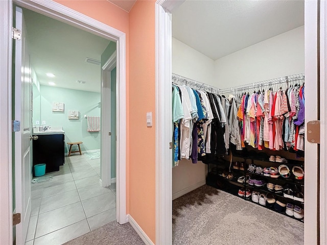 spacious closet with light colored carpet