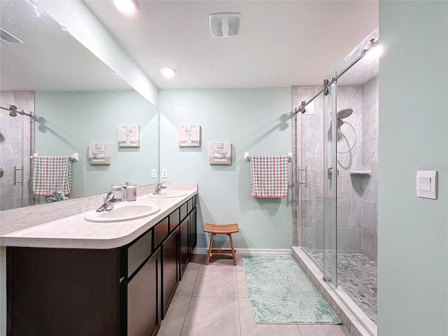 bathroom with tile patterned flooring, vanity, and a shower with shower door