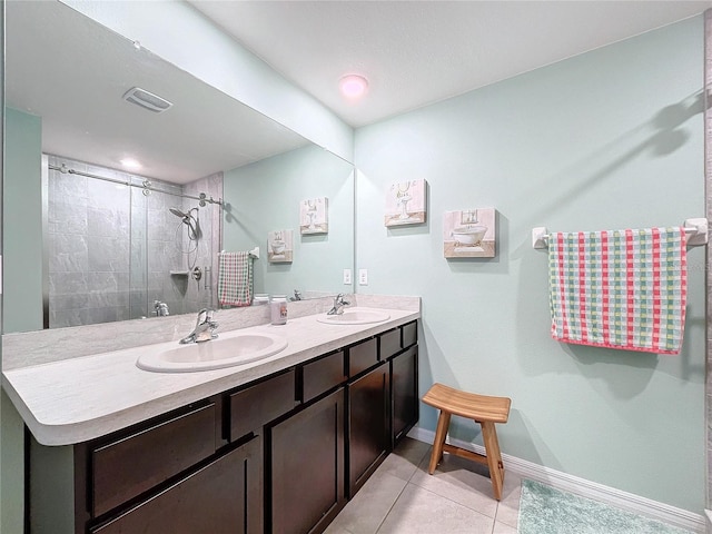 bathroom with tile patterned flooring, vanity, and walk in shower