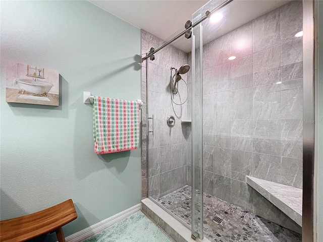 bathroom featuring a shower with door