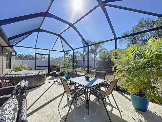 view of patio with a lanai and a hot tub