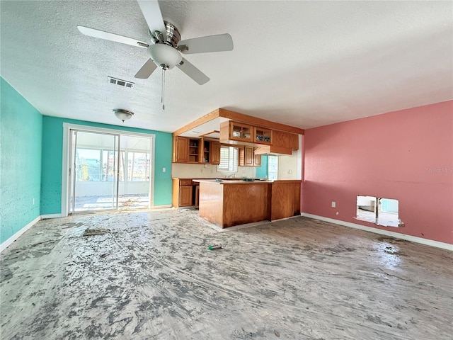 kitchen with kitchen peninsula, ceiling fan, and a textured ceiling