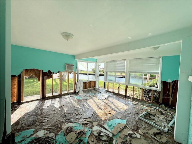 miscellaneous room with a wall mounted air conditioner and a water view