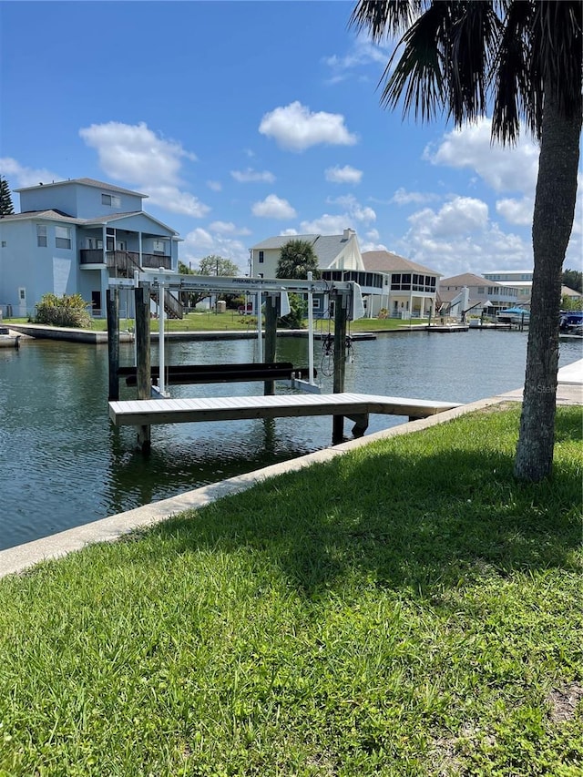 dock area featuring a water view and a yard